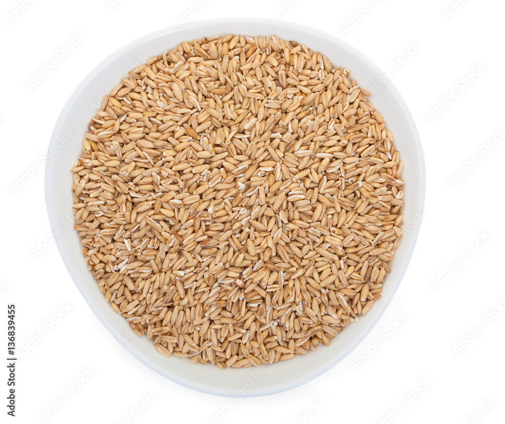 Grain oats in a white ceramic plate, isolated on a white backgro Grain oats in a white ceramic plate, isolated on a white backgro