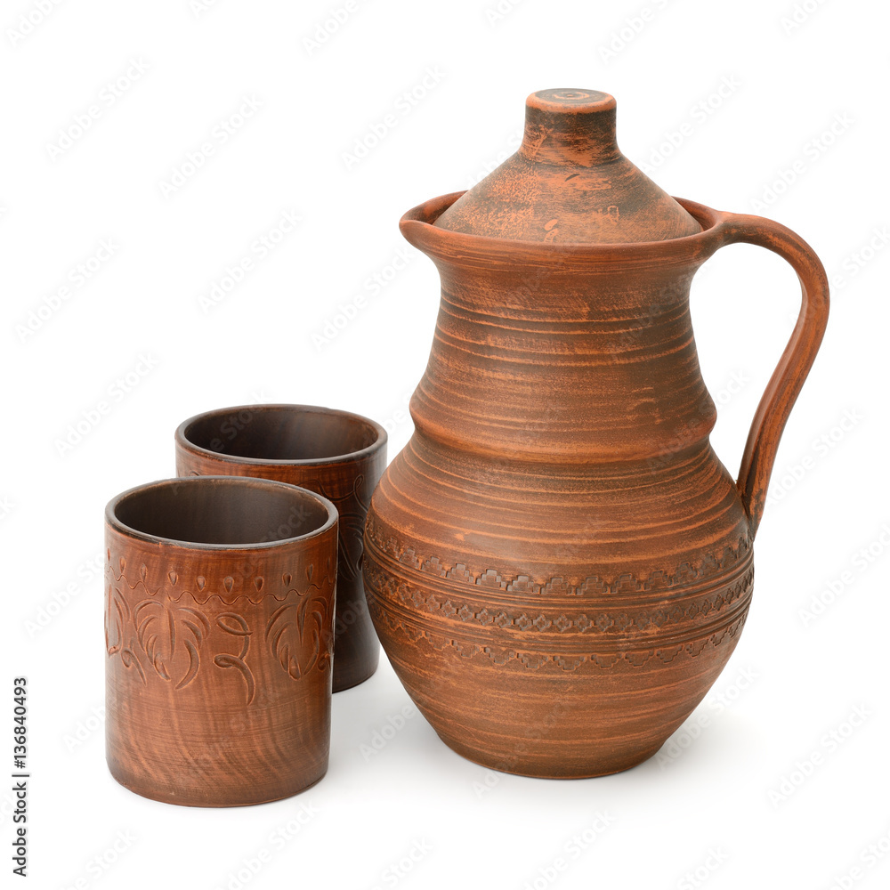 Clay jug and cup isolated on white