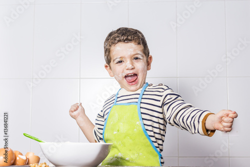 Excited child spotted with flour