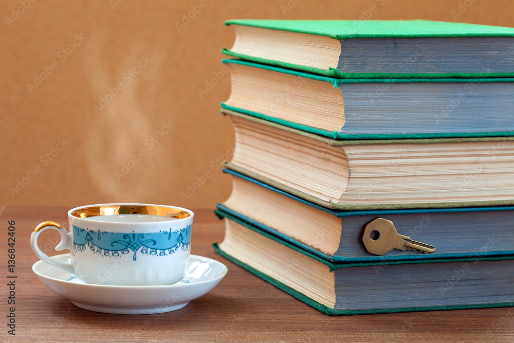 book firm cover with a cup on a wooden table. book firm cover with a cup on a wooden table.