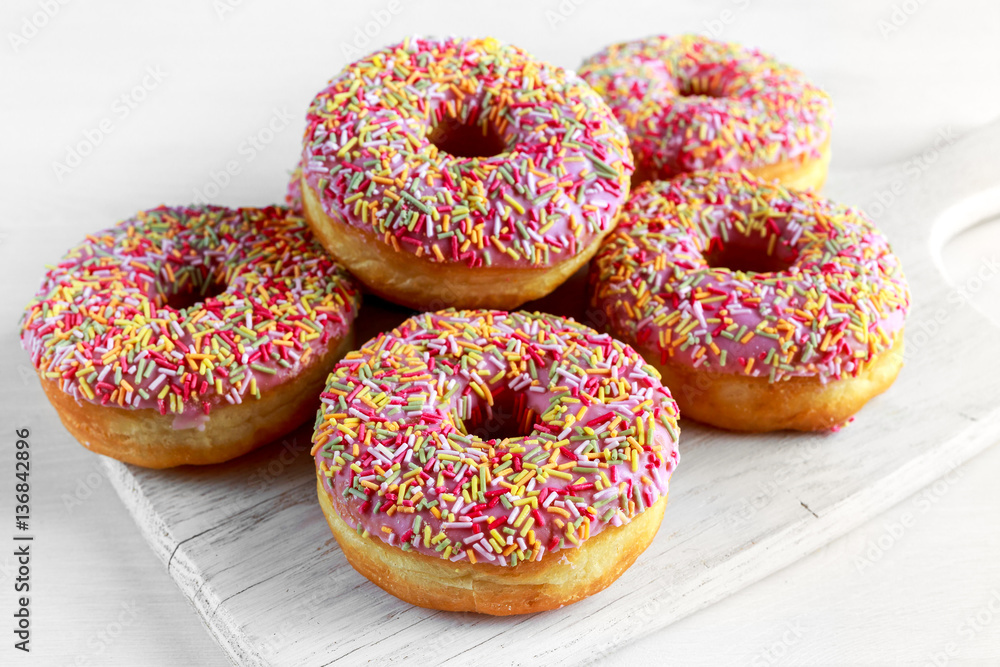 Iced doughnut rings with rainbow sparkl strands. Iced doughnut rings with rainbow sparkl strands.