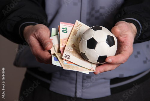 Soccer ball and money in hand