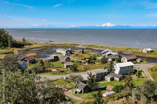 Aerial view of Ninilchik a small Alaskan Native village with Cook Inlet and Aleutian volcanoes in the background, Kenai Peninsula, Alaska