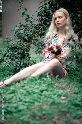 Fototapeta Naklejka Na Ścianę i Meble -  happy young blondie european woman on the grass