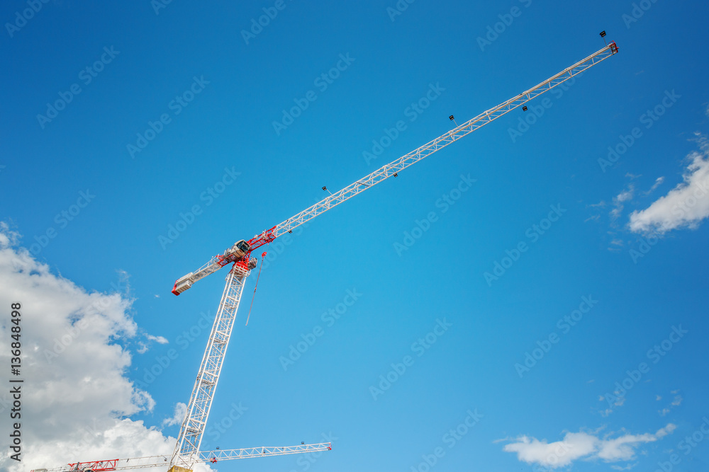 Construction crane at blue sky background.