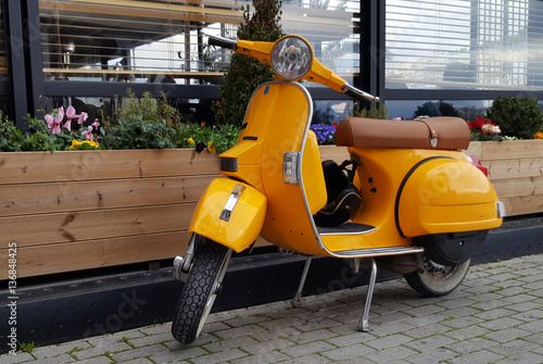 Chalkida, Greece - February 11, 2017: Yellow  scooter parked in a town Chalkida, Greece © Balint Radu