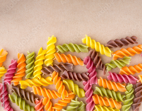 Background of colorful pasta texture close-up. Assortment of colorful macaroni. italian pasta. Variety of types and shapes of dry Italian pasta. Full background of dry uncooked macaroni.