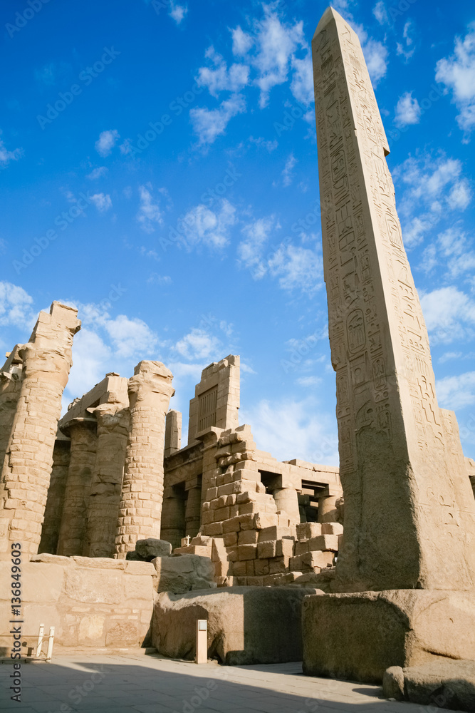 big obelisk of Queen Hatshetsut with carving figures and hieroglyphs in landmark Egyptian Karnak Temple, public monument declared a World Heritage by Unesco, in Luxor, Egypt, Africa
