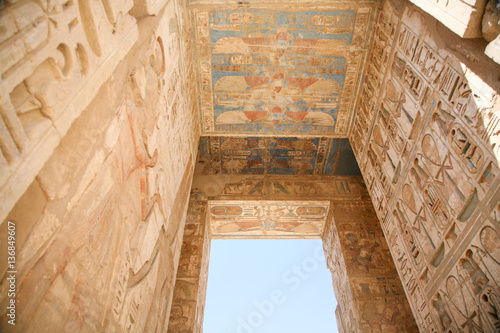 ceiling and wall of landmark Egyptian mortuary Temple of Ramses or Ramesses III at Medinet Habu, monument with carving figures and hieroglyphs, in Luxor, Egypt, Africa

