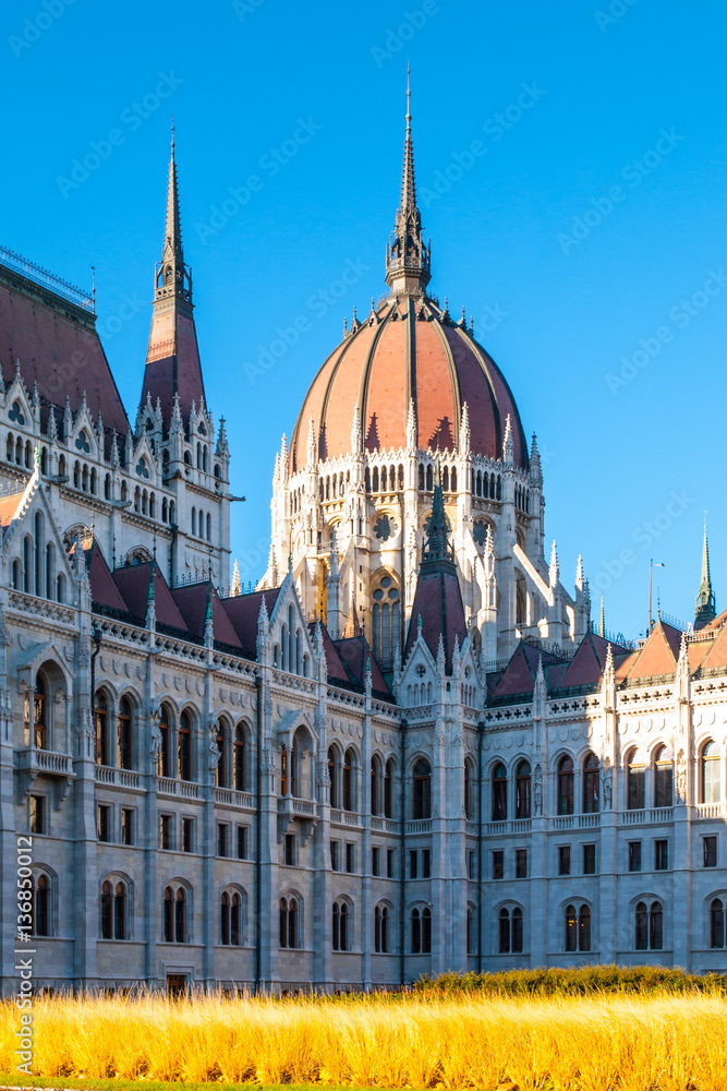Fototapeta premium Daytime view of historical building of Hungarian Parliament, aka Orszaghaz, with typical central dome in Budapest, Hungary, Europe. It is notable landmark and seat of the National Assembly of Hungary