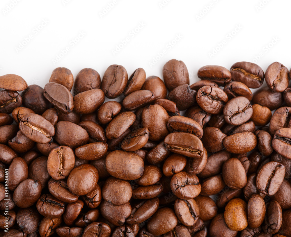 roasted coffee beans isolated in white background. Roasted coffee beans background close up. Coffee beans pile from top on white background with copy space for text. Good morning. roasted coffee beans isolated in white background. Roasted coffee beans background close up. Coffee beans pile from top on white background with copy space for text. Good morning.