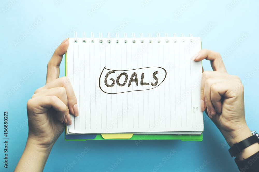goals text on notepad on woman hand goals text on notepad on woman hand