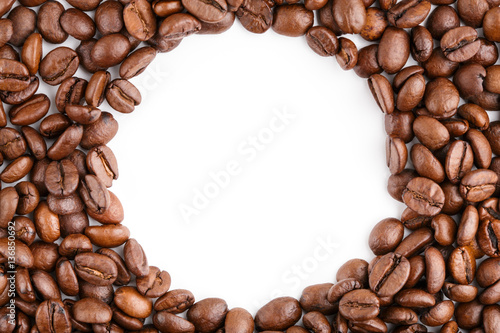 roasted coffee beans isolated in white background. Roasted coffee beans background close up. Coffee beans pile from top on white background with copy space for text. Good morning.