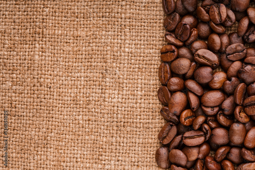 coffee beans on burlap background. roasted coffee beans isolated in white background. Roasted coffee beans background close up. Coffee beans pile from top on white background with copy space for text coffee beans on burlap background. roasted coffee beans isolated in white background. Roasted coffee beans background close up. Coffee beans pile from top on white background with copy space for text