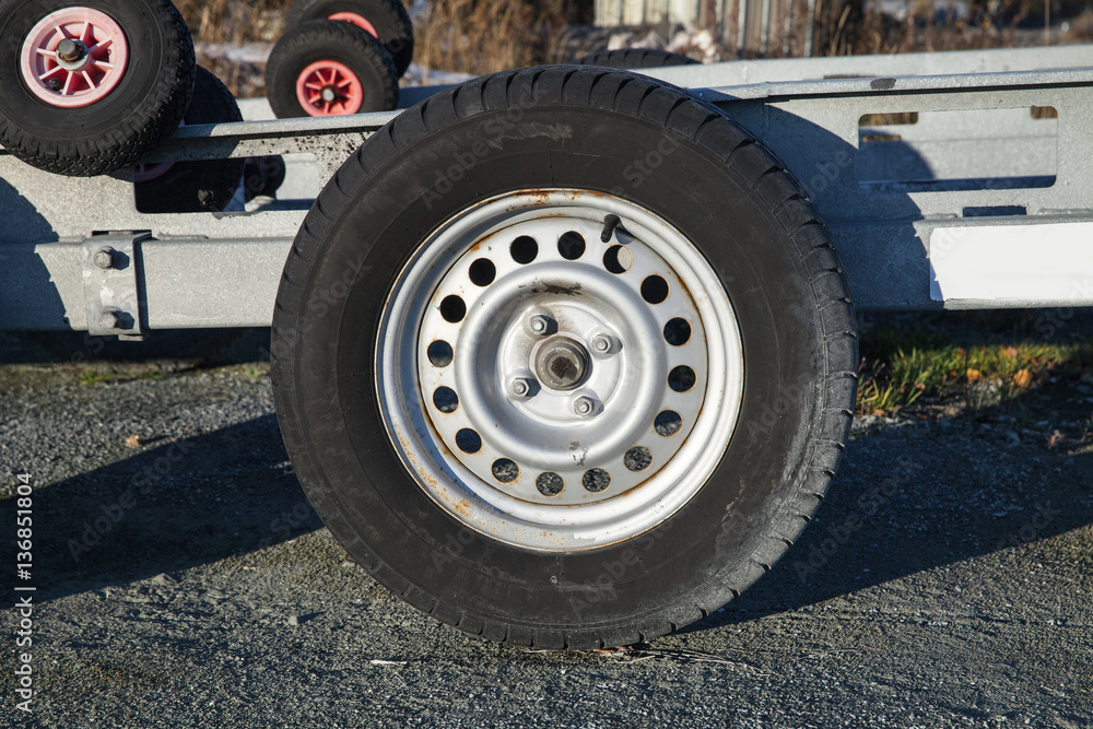 Closeup photo of trailer wheel on road Closeup photo of trailer wheel on road