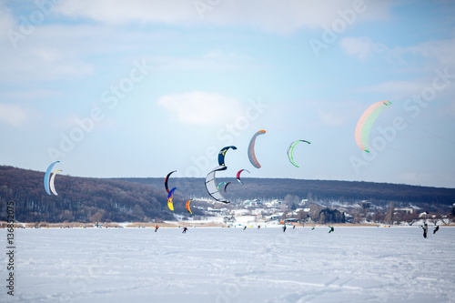 snow kiting on a snowboard on a frozen lake