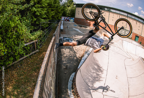 Man performing stunt on bike at skate park 