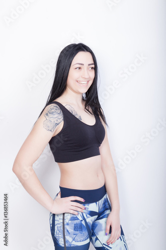 Cheerful athletic woman brunette. Woman in black sports top