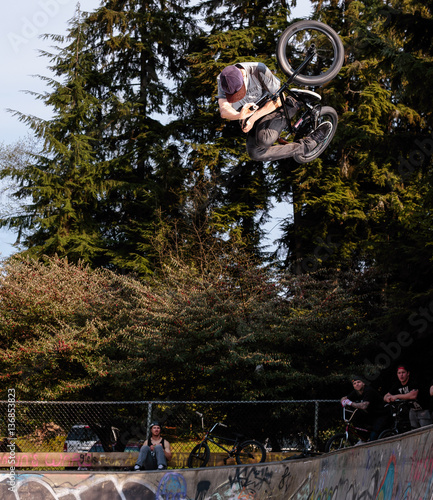 Man performing stunt on bike to onlookers