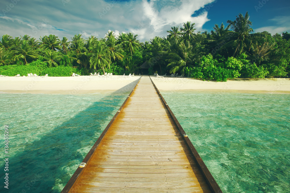 Wooden pier at tropical island resort. Indian Ocean, Maldives