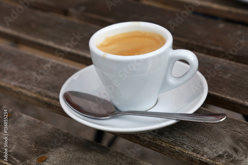 Fototapeta Naklejka Na Ścianę i Meble -  Espresso coffee in white cup close up on table