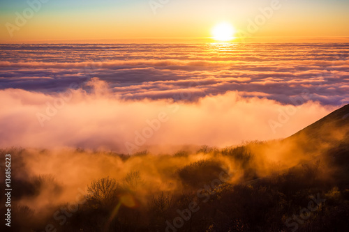 Beautiful sunset with clouds and mountains. On high.