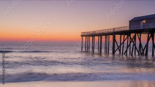 Sunrise Timelapse Video of Atlantic Ocean from New Jersey Beach with Pier  photo