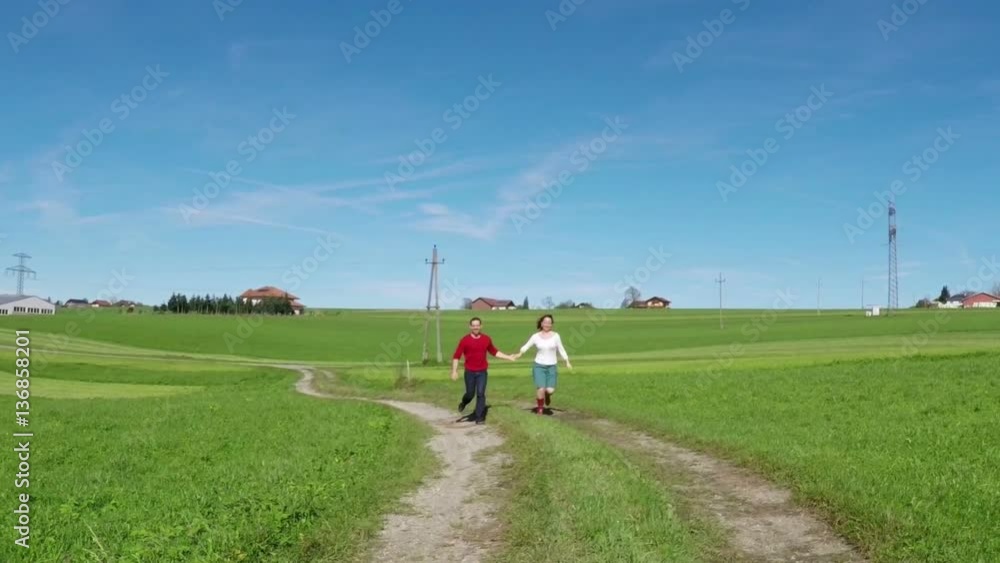 Romantic couple running in nature scenic, slow motion Romantic couple running in nature scenic, slow motion