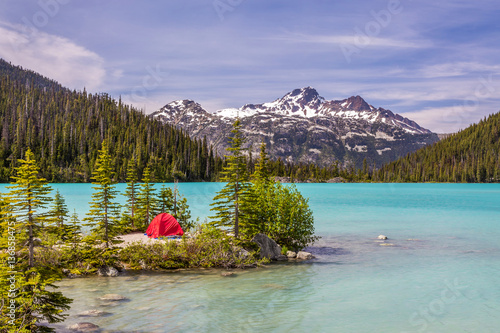 This red tent offer a nice contrast with the turquoise water of Upper Joffre Lake in British Columbia, Canada photo
