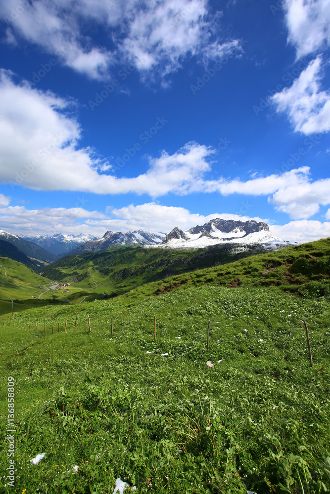 Mountain landscape with green meadows and sunshine Mountain landscape with green meadows and sunshine