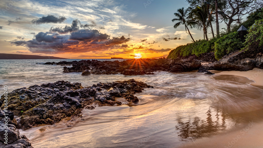 a dramatic sunset on the tropical island of Maui, Hawaii from secret cove - obrazy, fototapety, plakaty 