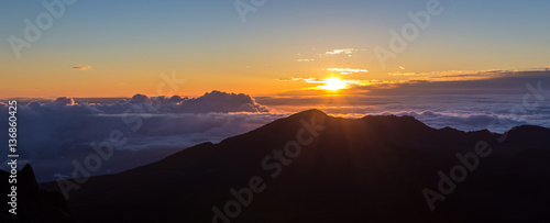sunrise above the clouds at 10000 feet  from the summit of Haleakala volcano on the tropical hawaiian island of Maui