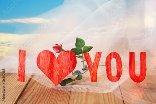 Bild auf Leinwand Red heart and the rose on wooden boards against the blue sky on Valentine's Day