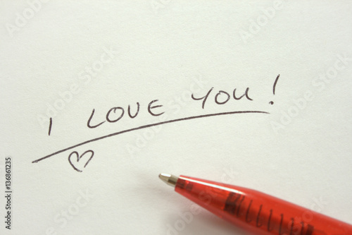 Handwritten I Love You note on white paper