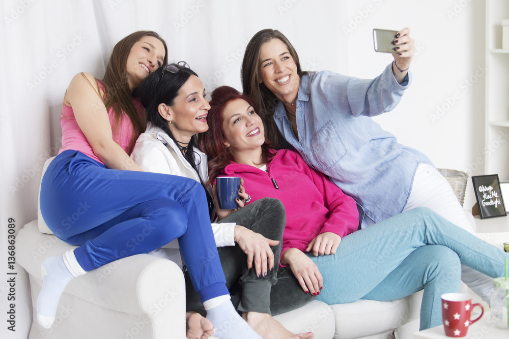 Friends having fun in the living room and taking selfie
