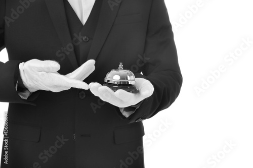 Man in suit with service bell on white background, closeup