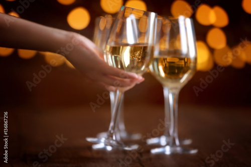 Wallpaper Mural Female hand taking wine glass on bokeh background Torontodigital.ca