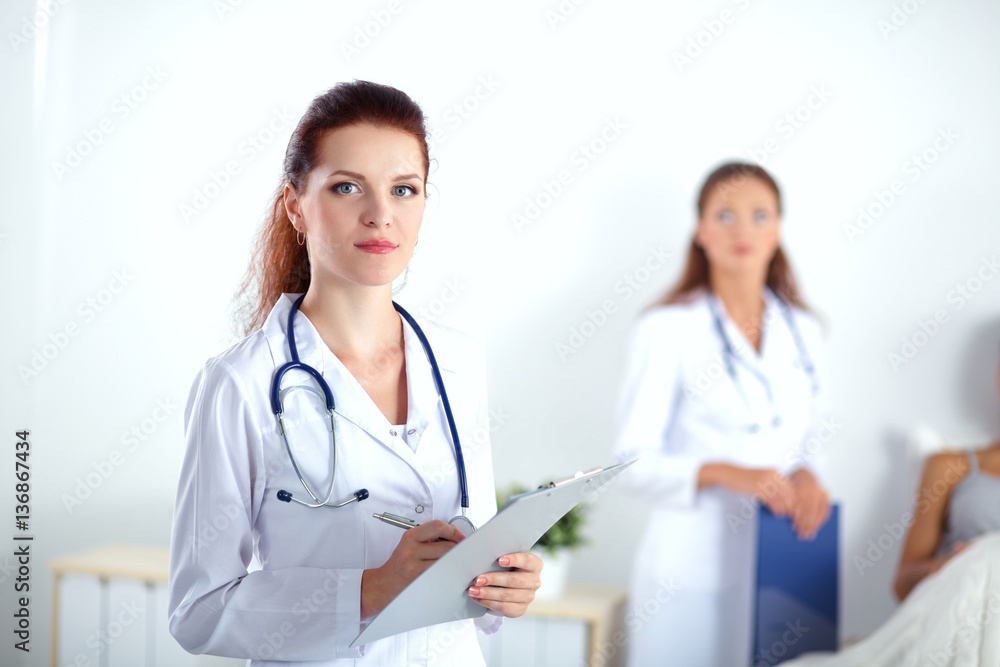 Woman doctor with folder standing at hospital Woman doctor with folder standing at hospital