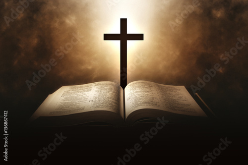 Holy Bible with a cross and a light coming from above