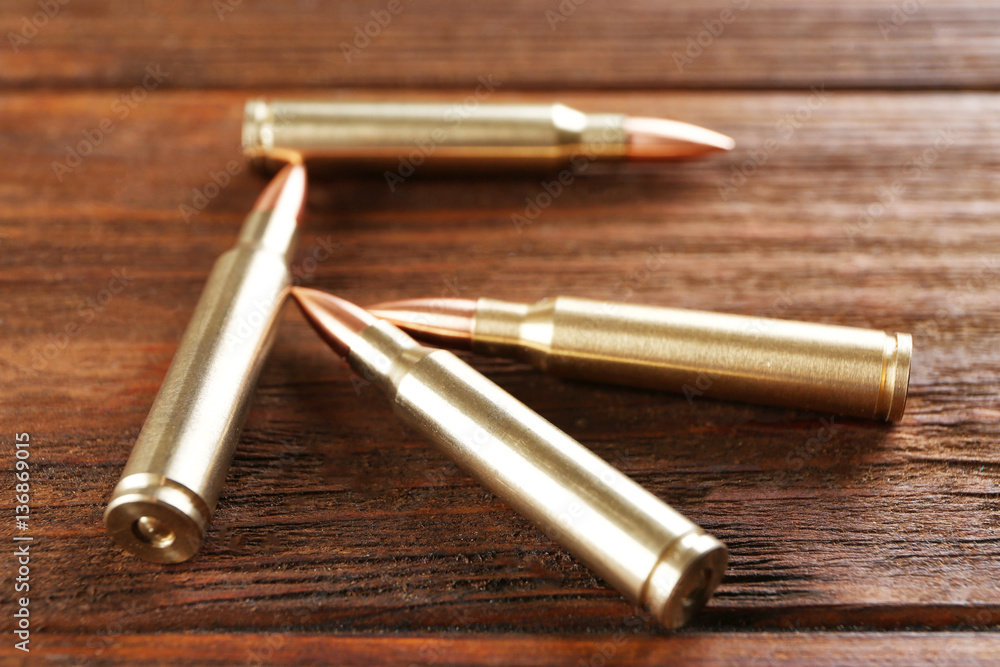 Bullets on wooden background Bullets on wooden background