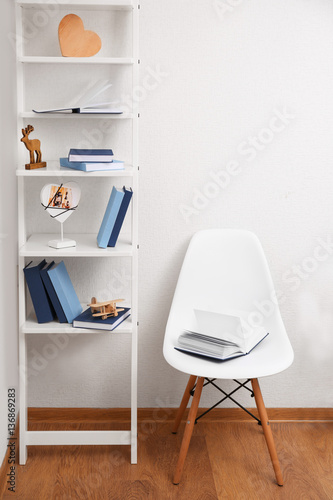 Opened book on chair in the room © Africa Studio