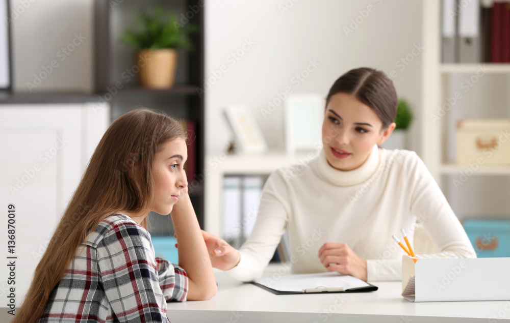 Young female psychologist working with teenager girl in office Young female psychologist working with teenager girl in office