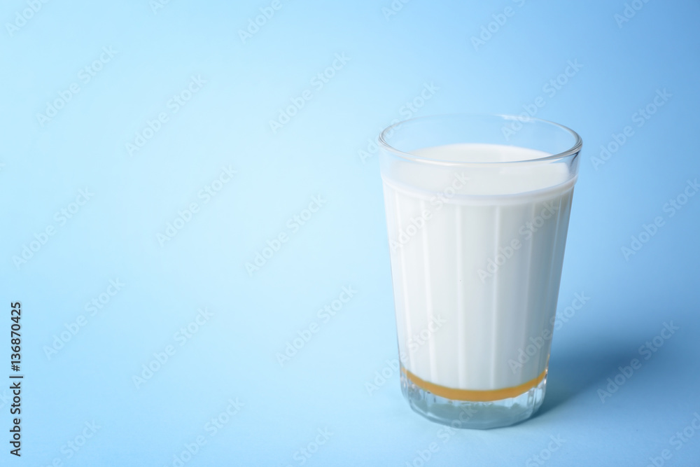 Glass of milk with honey on blue background Glass of milk with honey on blue background
