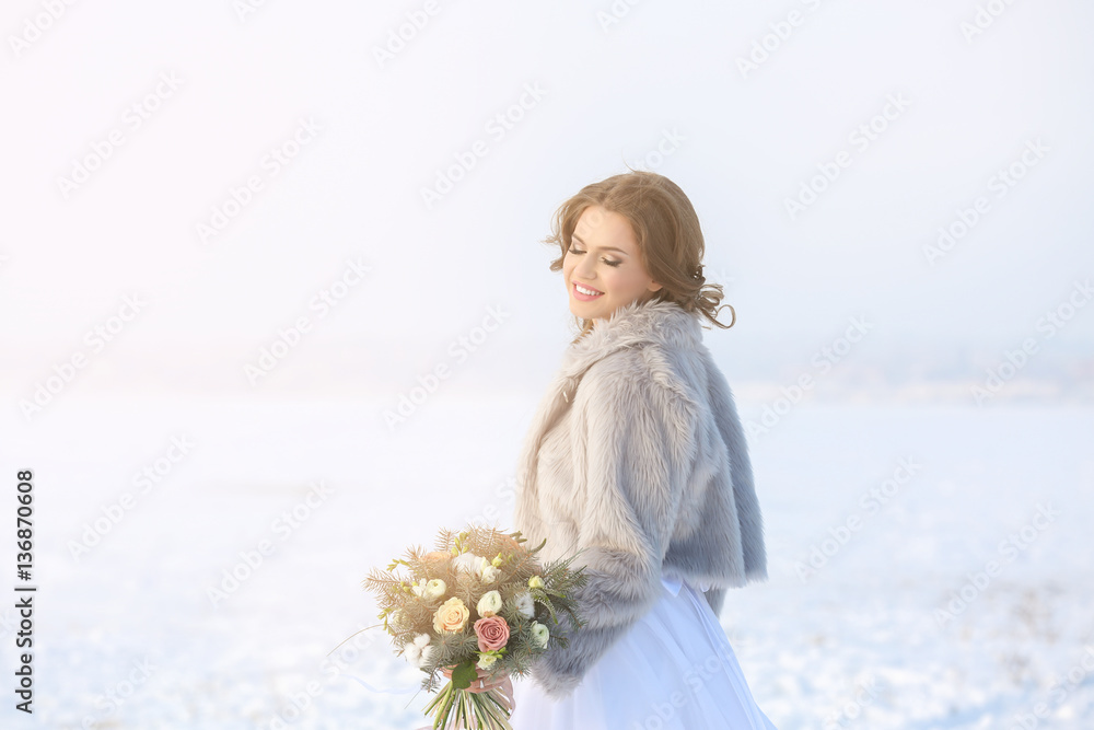 Beautiful bride with bouquet outdoors on winter day Beautiful bride with bouquet outdoors on winter day