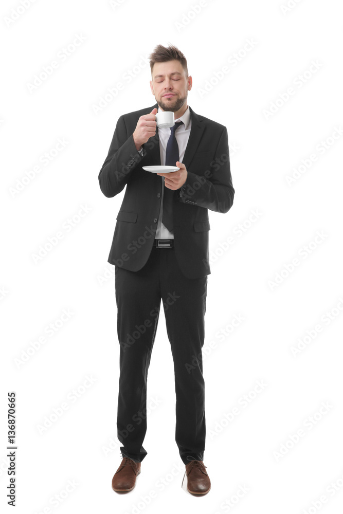 Young business man with closed eyes holding cup of coffee trying to wake up, isolated on white Young business man with closed eyes holding cup of coffee trying to wake up, isolated on white