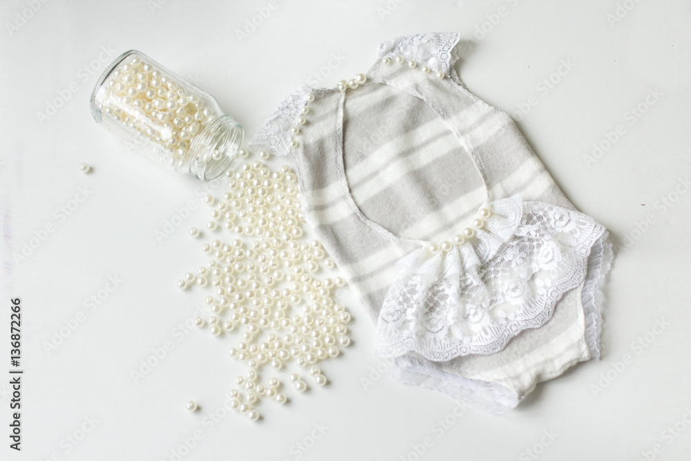 Clothing for newborns rasschita beads on a white background. han Clothing for newborns rasschita beads on a white background. han