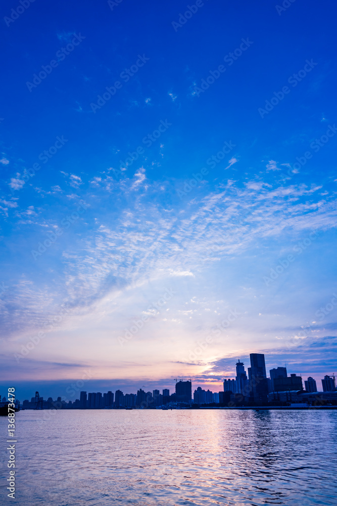 City Skyline By River Against cloudy Sky in Shanghai,China.