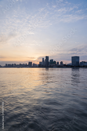 City Skyline By River Against cloudy Sky in Shanghai,China.