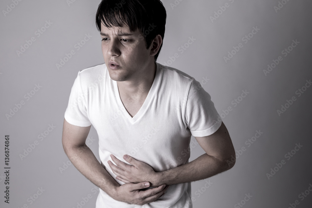 young man having a stomachache young man having a stomachache