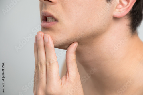 Young man checking his skin, men's skincare concept, acne treatment